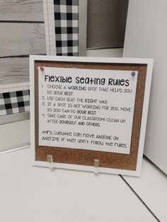 a sign that is on top of a white table next to some wood planks