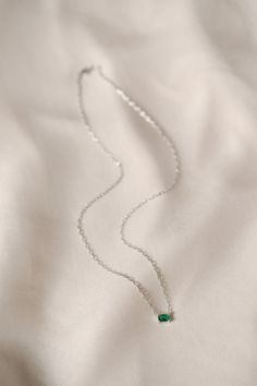 The Ezra Pavé Chain Necklace showcases one gleaming stone on a graceful chain, a brilliant accent for your daily necklace stack. Part of our Stackable Jewelry assortment. Chain necklace with one claw-set emerald cut simulated stone. Gold: 18K gold plated brass. Silver: rhodium plated brass. Nickel- and lead-free. 16" long with 2" extender. Avoid water, soap, and harsh chemicals. Store in a box or bag in a cool, dry place. Clean using a dry soft cloth. Green Emerald Necklace With Adjustable Chain, Elegant Green Birthstone Necklace With Delicate Chain, Emerald Necklace With Delicate Chain As Gift, Emerald Necklace With Delicate Chain For Gift, Emerald Necklace With Delicate Chain For May Birthstone, May Birthstone Emerald Necklace With Delicate Chain, Silver Emerald Necklace With Clavicle Chain As Gift, Emerald Jewelry With Delicate Chain As Gift, Emerald Jewelry With Delicate Chain For Gift