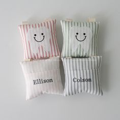 three pillows with tooth shaped faces on them