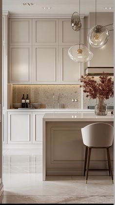 an elegant kitchen with marble floors and white cabinetry, along with modern lighting fixtures