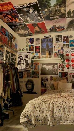 a bedroom with posters on the wall and bed in it's centerpieces