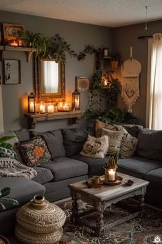 a living room filled with lots of furniture and candles on top of the couches