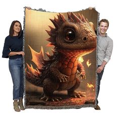 a man and woman standing next to a large tapestry with a dragon on it's face