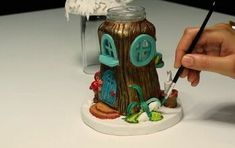 a person is painting a small tree stump