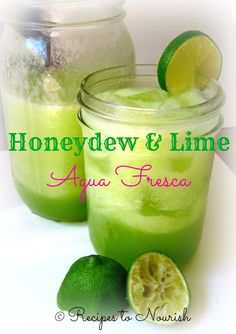 two mason jars filled with green liquid and limes