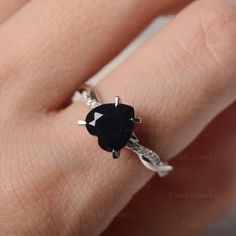 a woman's hand with a black and white diamond ring