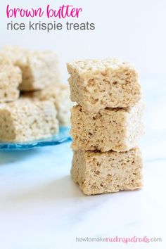 three pieces of rice krispy treats stacked on top of each other in front of a plate