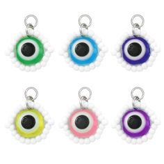 six different colored charms with an eye on them