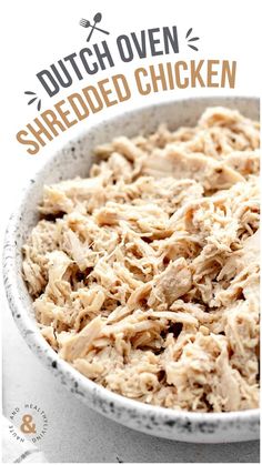 a white bowl filled with shredded chicken on top of a table