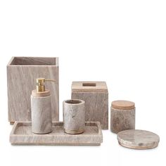 marble bathroom accessories including soap dispenser, toothbrush holder and sponge dish