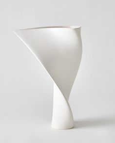 a white vase sitting on top of a table