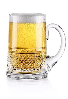 a glass mug filled with beer on top of a white table