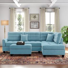 a living room with a blue couch and ottoman