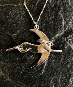 Hare and moon pendant necklace in pewter by Paul Szeiler. Available with 16 , 18 , 20 or 22 , inch sterling silver chain. Handmade in the Highlands of Scotland. The Hare and moon pendant is 6 cm wide. Once purchased your Hare pendant will be securely packaged and posted to you within 3 working days.