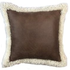 a brown and white pillow with sheep fur on the bottom, in front of a white background