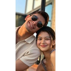 a man and woman are smiling for the camera with sunglasses on their faces while they pose for a photo