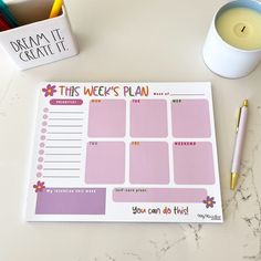 this week's plan is displayed next to a cup of coffee and a candle