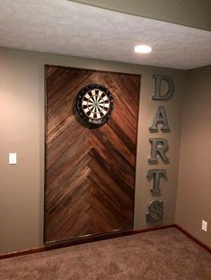 the darts sign is mounted on the wall next to the darts door in this game room