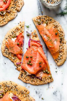 four pieces of bread with salmon on them