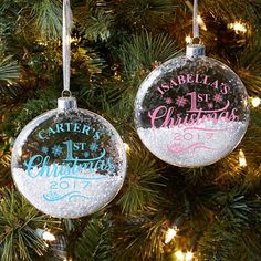 two personalized christmas ornaments hanging from a tree