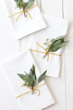 four napkins with green leaves tied to them