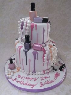 a three tiered birthday cake decorated with nail polish