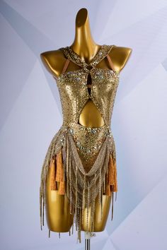 a mannequin with gold sequins and tassels on it's back