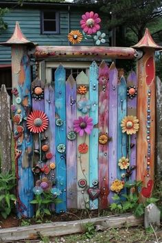 a colorful fence with flowers on it in front of a house