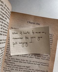 an open book with a piece of paper on top of it that says, when it hurts to move only remember the pain you felt hang off