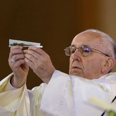 a man holding up a small piece of paper