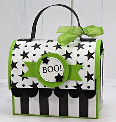 a black and white bag with stars on the front, green ribbon around the top