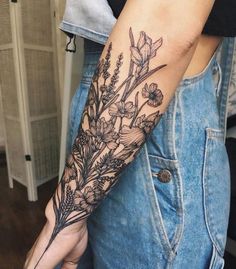 a woman's arm with flowers on it