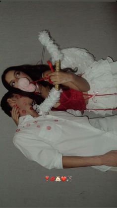 two people dressed up as angels and devil