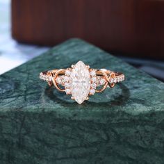 a diamond ring sitting on top of a green marble slab