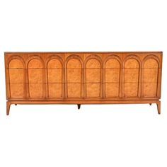 an art deco sideboard with arched doors