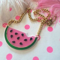 "This is a scrumptious necklace for all seasons! Bring the fun to any outfit with this big and bold watermelon necklace. This original design has been laser cut out of a mix of glitter, mirror, and opaque 1/8\" acrylic sheet and is backed with white, 1/16\" acrylic. The necklace hangs from a thick, gold chain and measures about 16\". We love these necklaces and think that they never get old. However, to prolong the life of yours, treat it with love! Be careful when storing it in a bag or pocket Cute Pink Resin Necklace, Cute Summer Party Necklaces, Cute Party Necklaces For Summer, Fun Summer Necklaces For Gifts, Trendy Handmade Resin Necklace, Pink Resin Party Necklaces, Trendy Resin Necklaces For Party, Fun Resin Jewelry For Parties, Fun Resin Jewelry For Party