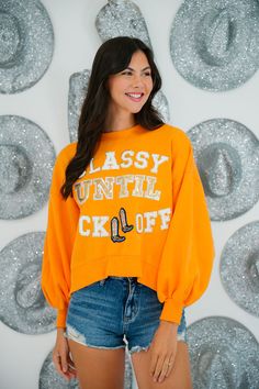 This limited-edition CLASSY UNTIL KICKOFF COLORFUL PULLOVERS is perfect for the ultimate style-conscious sports enthusiast. It features a cropped pullover with various patches, plus the words "Classy Until Kickoff" for a bold, game-ready look. Get ready to dominate the gameday fashion scene! All orders are currently shipping within 14 business days. To receive item quicker, expedited shipping is available at checkout. Classy Until Kickoff, Gameday Fashion, Orange Pullover, Bold Letters, Cropped Pullover, Pink Yellow, Cowboy Boots, Orange Color, Yellow White