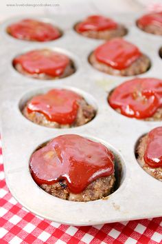 an image of some food that is in the muffin tins with ketchup on top