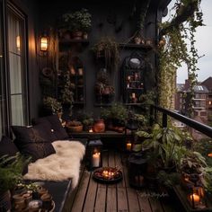 a balcony with potted plants and candles