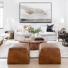 a living room filled with furniture and a painting on the wall