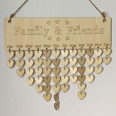 a family and friends wooden sign hanging from a string with hearts on the front, attached to a wall