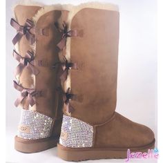 ✨Your feet will ❤️ you for these UNBELIEVABLE Women's Bailey Bow UGG® II Boots with Ultra-Premium Crystals✨ In addition to these TALL STYLE Uggs having THREE satin Bows down the back, adding a cute variation to a classic style. There is NO COMPARISON to the craftsmanship and design that Jezelle.com delivers. Each pair is a work of art held to the highest standards with a quality that is unsurpassed and untouchable. OVER 1300(!!) Ultra-Premium Crystals each hand-jeweled with precision! UGG® AUSTR Style Uggs, Bow Ugg, Bow Uggs, Uggs With Bows, Ugg Boots Australia, Bailey Bow Uggs, Custom Bling, Bow Boots, Bailey Bow