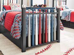 a baby crib with red, white and blue bedding