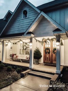 a house with christmas decorations on the front porch