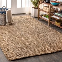 a living room area with a rug, couch and coffee table