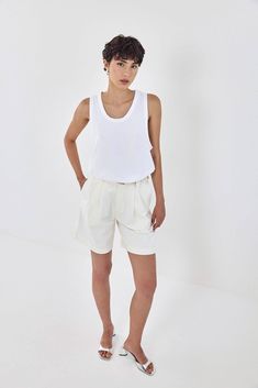 The perfect tank top is an absolute summer wardrobe essential. Boxy silhouette. Sits loosely on the body. Made from a thick heavy cotton composition, maintaining its shape all day long. Embroidered tonal logo detailing at the front of the shirt, just above the waistline. Style it a denim mini skirt, croco belt and a pair of chunky loafers to easily attain Parisian effortless chicness. 100% Cotton Color: White Care: Machine wash 30° on reverse side. Do not tumble dry. Dry in shade. Do not bleach. Classic Cotton Tank Top For Daywear, Basic Relaxed Fit Muscle Tee For Summer, White Relaxed Fit Muscle Tee For Summer, White Cotton Tank Top For Daywear, White Muscle Tee For Everyday Summer Wear, Classic White Tank Top For Daywear, Sporty Tank Top For Everyday Summer Use, Basic Summer Muscle Tee For Everyday, Cotton Tank Top For Daywear