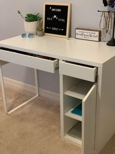 a white desk with an open drawer underneath it