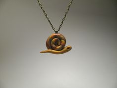 "This adorable little snail was hand-sculpted out of shimmering polymer clay and has liquid polymer streaks to resemble a \"slimy\" body. The pendant measures approximately 1-1/3  inches wide by 1 inch tall.  It is attached to an antique brass chain, which ends in a matching lobster clasp and decorated jump ring. The length of the necklace is 18 inches, with a 2-inch extender chain, allowing it to adjust up to 20 inches.  Come Snail Away!" Necklace Polymer Clay, Artisan Craft, Brass Chain, Etsy Crafts, Polymer Clay Jewelry, Jump Rings, Clay Jewelry, Pendant Necklaces, Antique Brass