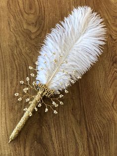 a white feather on top of a wooden table