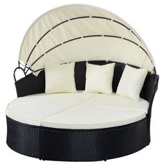 a black and white daybed with pillows on it's sides, against a white background